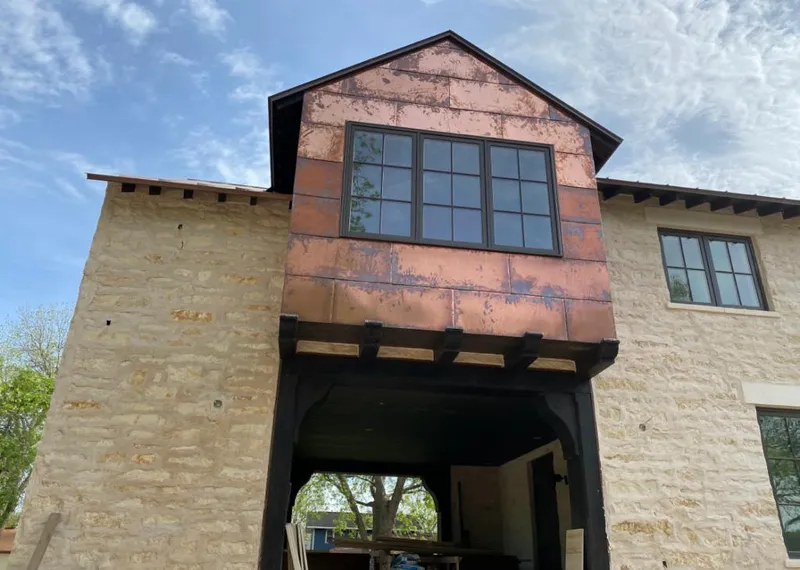 Copper metal panel facade on a stone building for Skylight Installation in North Lakes
